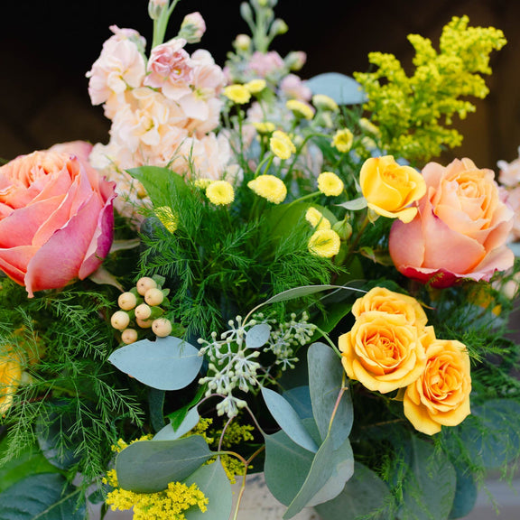 Bouquet of flowers with pink, yellow, and green colors.