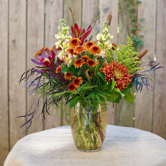 Bouquet of flowers in a clear vase on a wooden surface